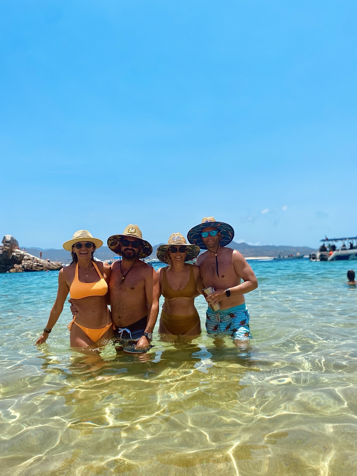 Laci and friends wading in turquoise water on vacation