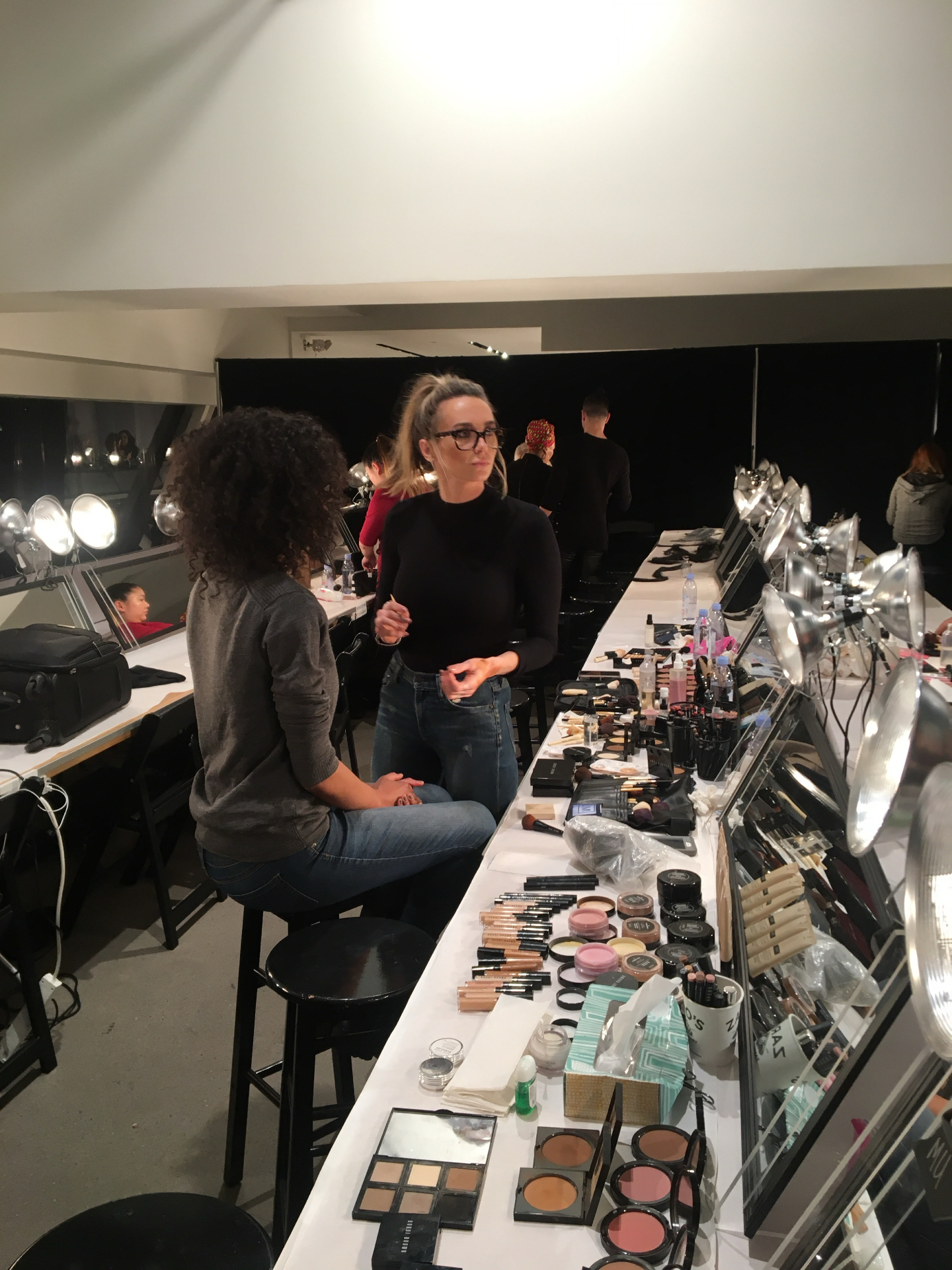 Laci working backstage at a professional makeup station